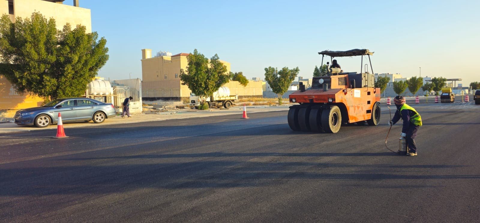 Roller compacting fresh asphalt on a city street